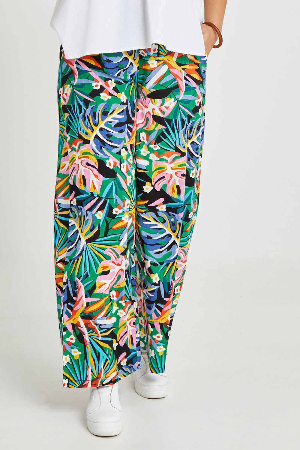 Model Terri-Leigh wearing size 14 of the Stella Print Pant in colour Rainforest (Blue), from the front, cropped image
