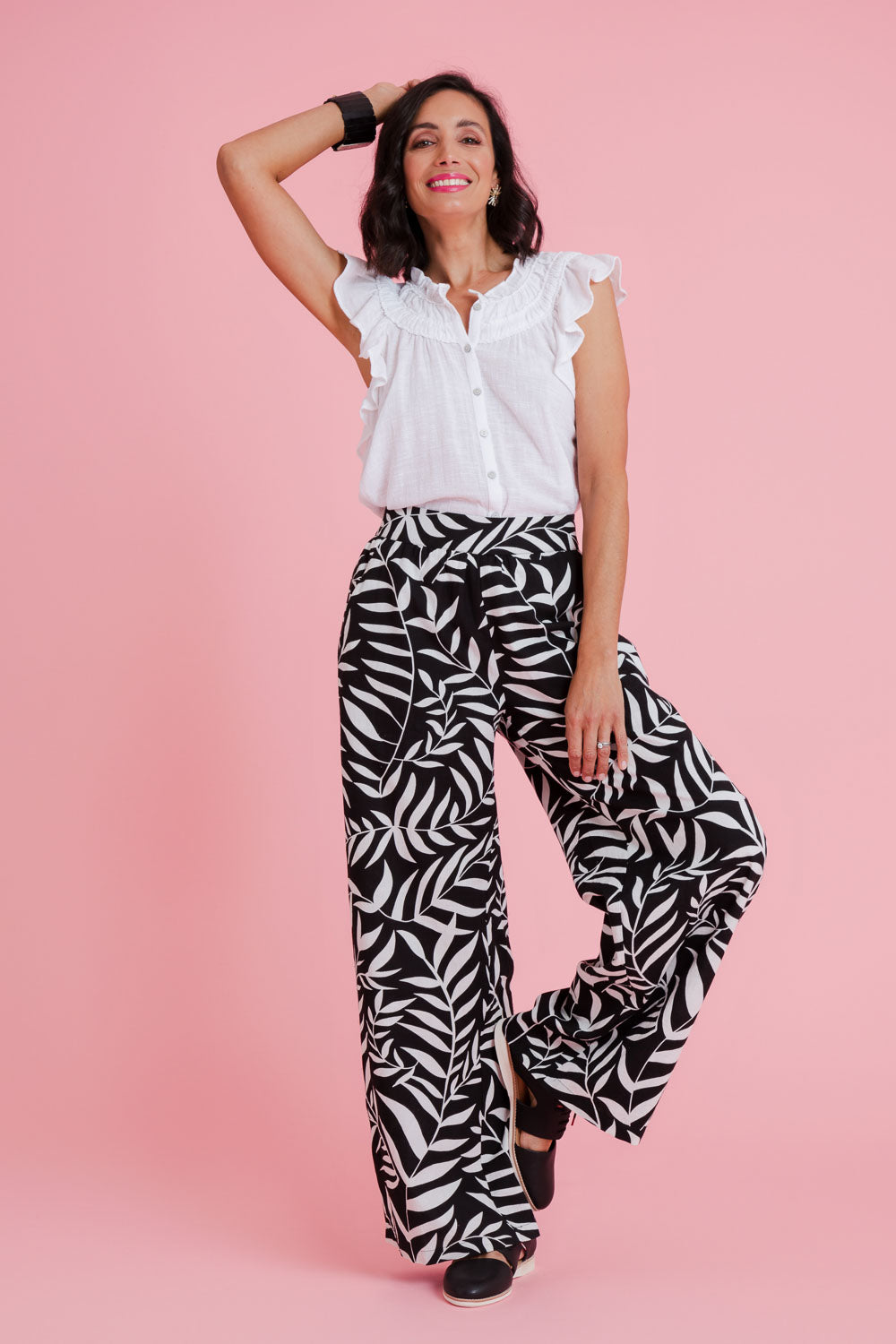 Model Natalie wearing size 10 of the Stella Print Pant in colour Vines (Black), from the front, showing the whole outfit