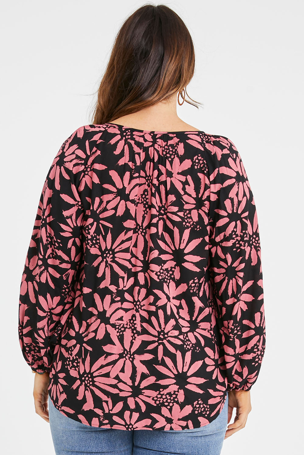 Model Laura wearing size 14 of the Jess Blouse in colour Flower (Black), from the back