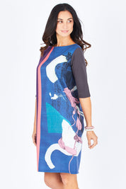Model Gemma wearing size 10 of the Farlee Dress in colour OceanBlue (Blue), from the front, cropped image