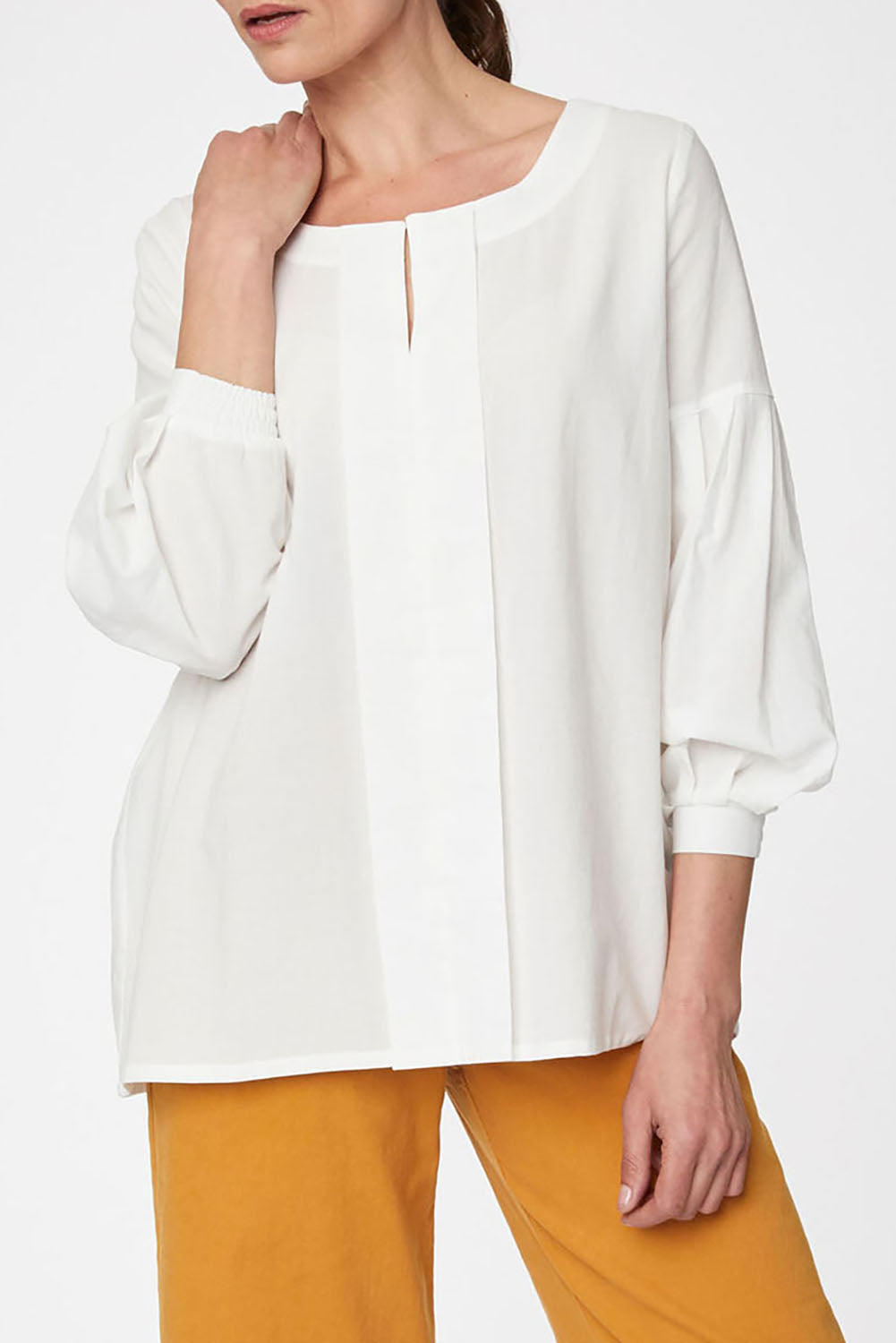 A model wearing the Benetta Blouse in colour White (White), from the front, cropped image