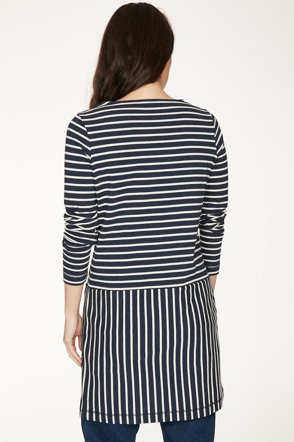 A model wearing the Hester Tunic Dress in colour Midnight (Blue), from the back