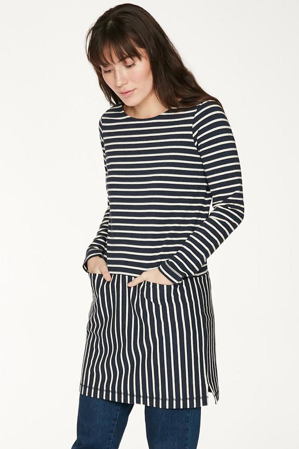 A model wearing the Hester Tunic Dress in colour Midnight (Blue), from the front, cropped image