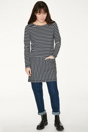 A model wearing the Hester Tunic Dress in colour Midnight (Blue), from the front, showing the whole outfit