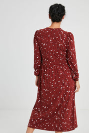 Model Katie wearing size 10 of the Eria Bamboo Wrap Dress in colour Oranrust (Red), from the back