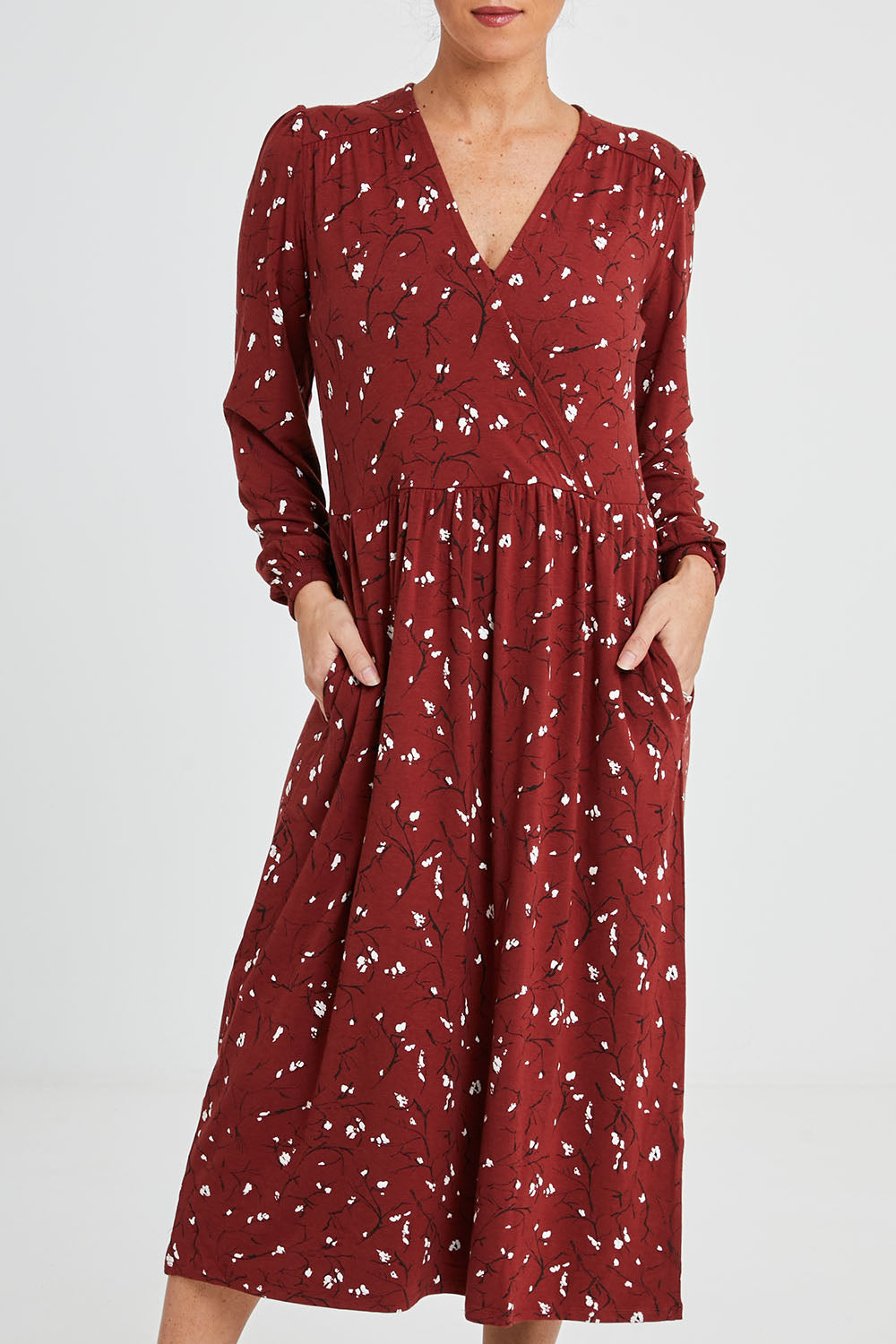 Model Katie wearing size 10 of the Eria Bamboo Wrap Dress in colour Oranrust (Red), from the front, cropped image
