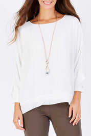 Model Anna wearing size S of the Layer Top in colour White (White), from the front, cropped image