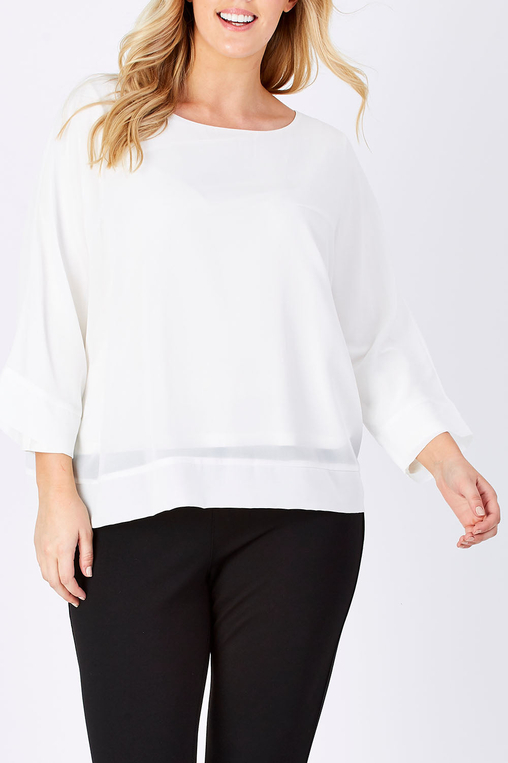 Model Jess wearing size M of the Layer Top in colour White (White), from the front, cropped image