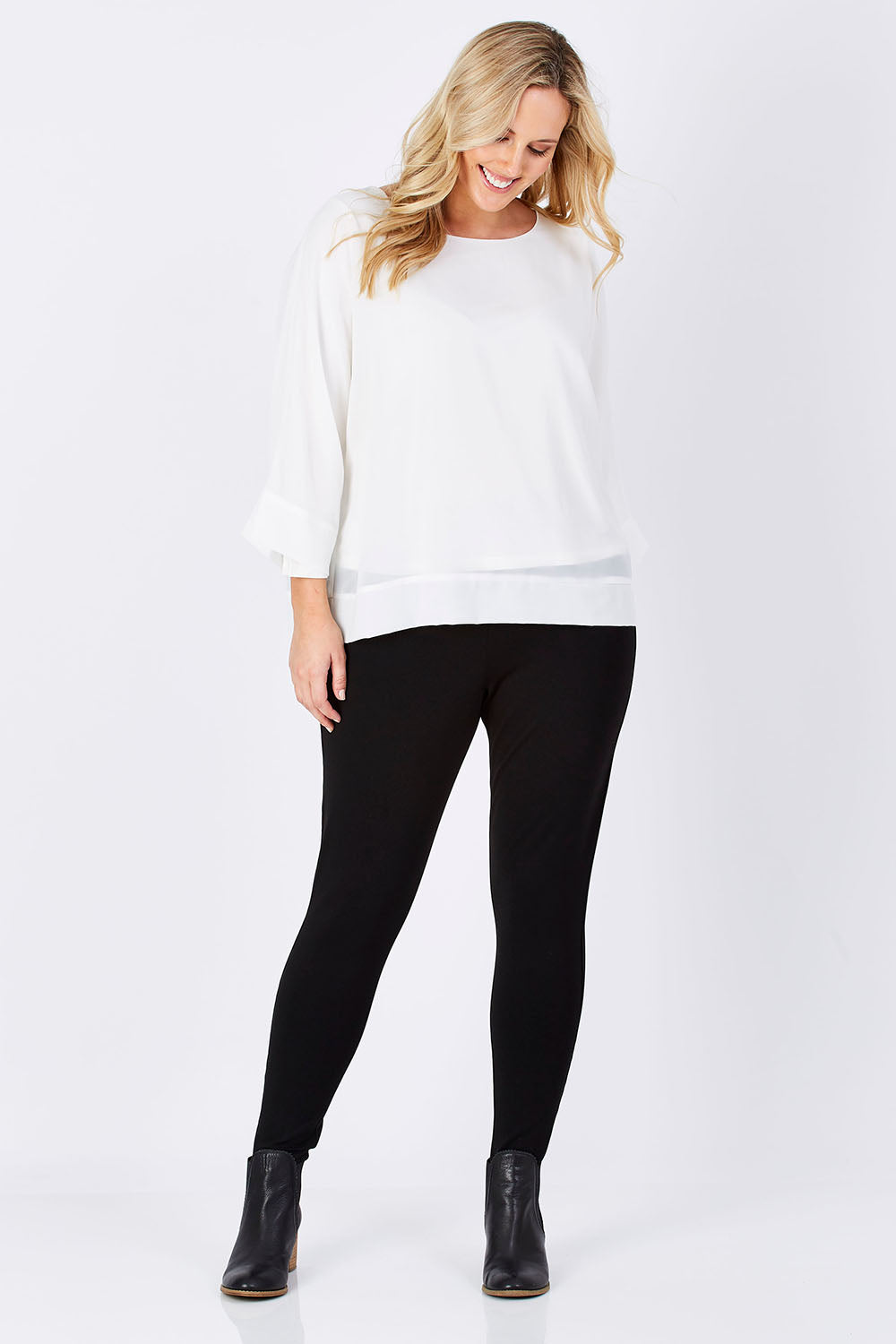 Model Jess wearing size M of the Layer Top in colour White (White), from the front, showing the whole outfit