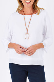 Model Louise wearing size S of the Layer Top in colour White (White), from the front, cropped image