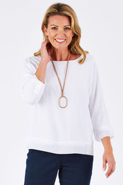 Model Louise wearing size S of the Layer Top in colour White (White), from the front, cropped image