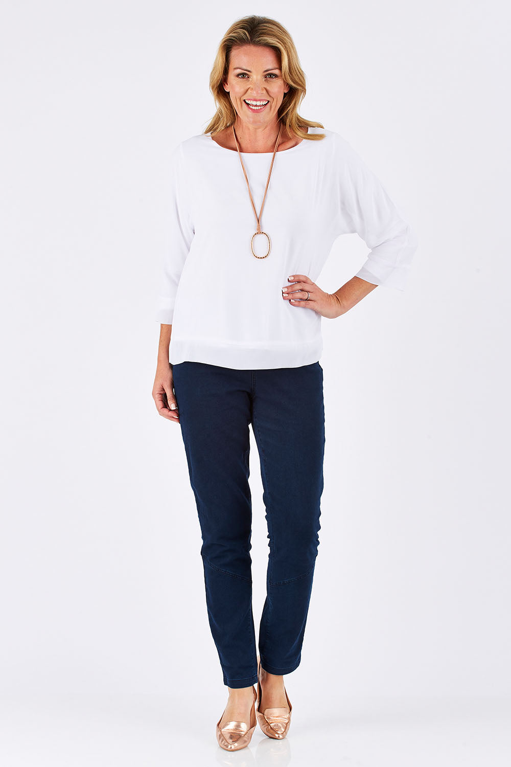 Model Louise wearing size S of the Layer Top in colour White (White), from the front, showing the whole outfit