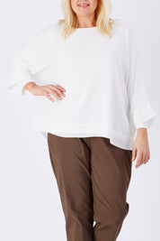 Model Natalie wearing size XL of the Layer Top in colour White (White), from the front, cropped image