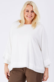 Model Natalie wearing size XL of the Layer Top in colour White (White), from the front, cropped image