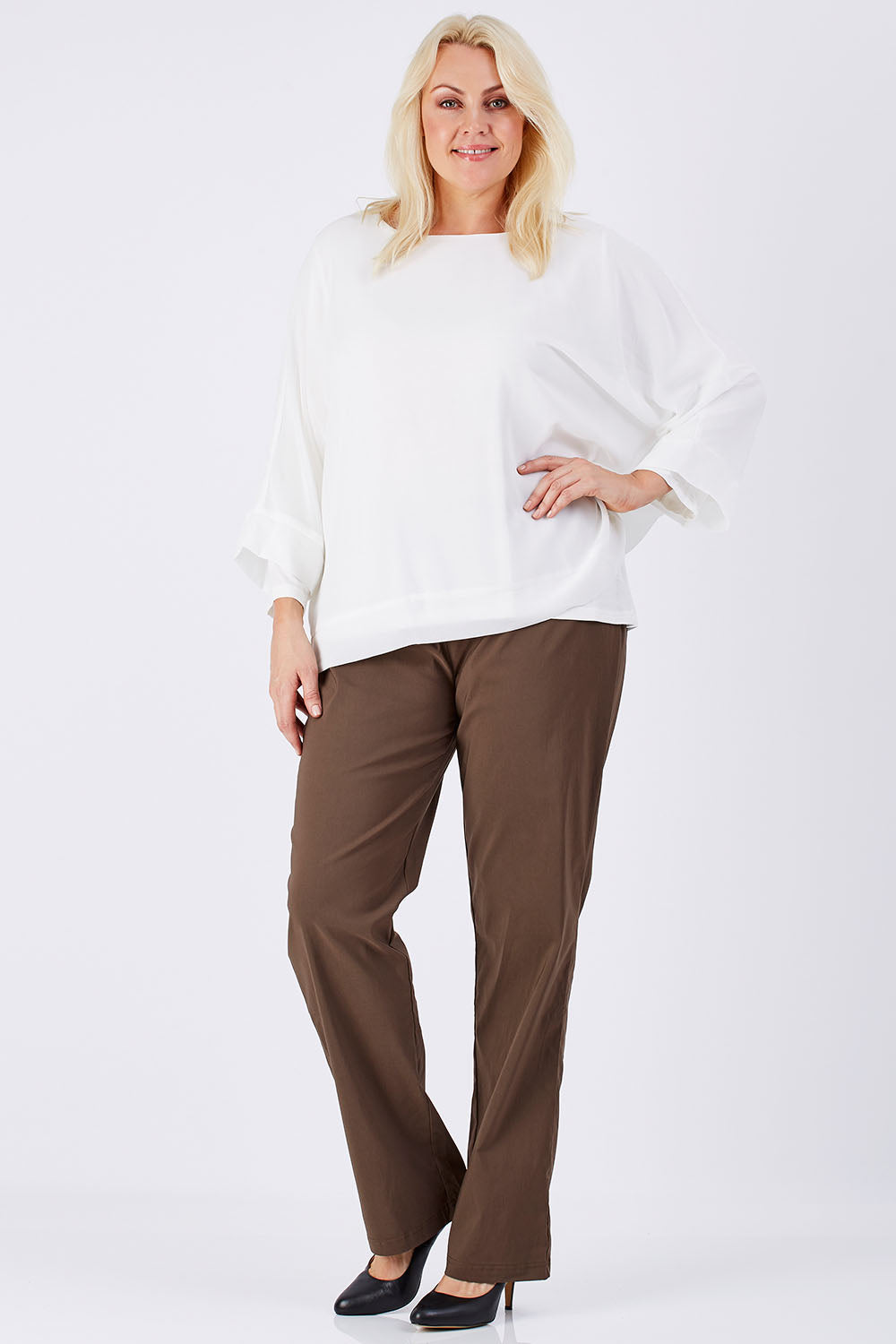 Model Natalie wearing size XL of the Layer Top in colour White (White), from the front, showing the whole outfit