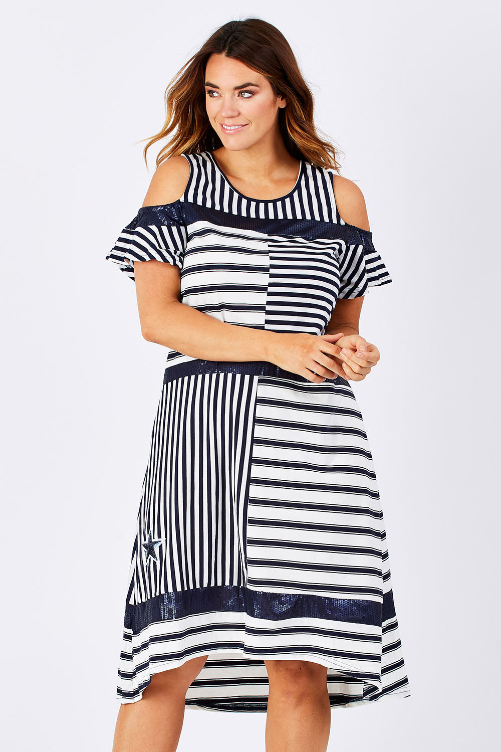 Model Laura wearing size M of the Star Stripe Dress in colour NavyWhite (Blue), from the front, cropped image