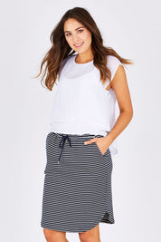 Model Madeline wearing size S of the Stripe Skirt in colour NavyWhite (Blue), from the front, cropped image