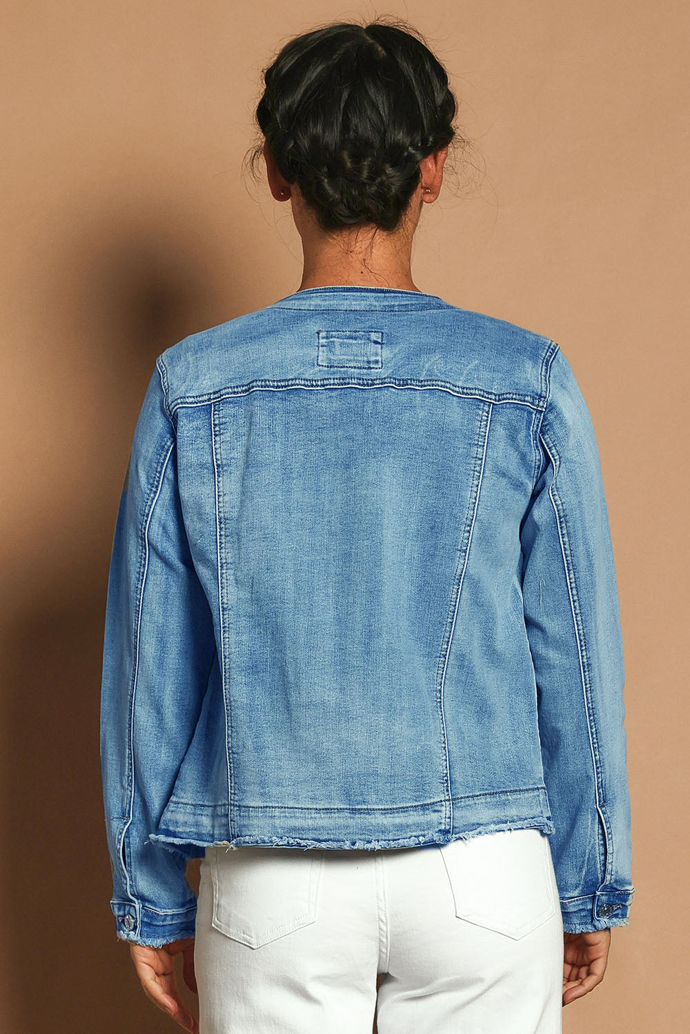 Model Katie wearing size S of the Collarless Jacket in colour Denim (Blue), from the back