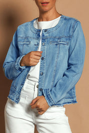 Model Katie wearing size S of the Collarless Jacket in colour Denim (Blue), from the front, cropped image
