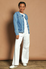 Model Katie wearing size S of the Collarless Jacket in colour Denim (Blue), from the front, showing the whole outfit