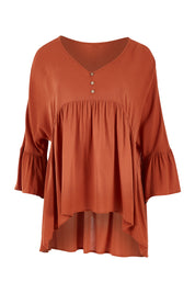 Product shot of the Ruffle Hem Top in colour Brick (Red), from the front