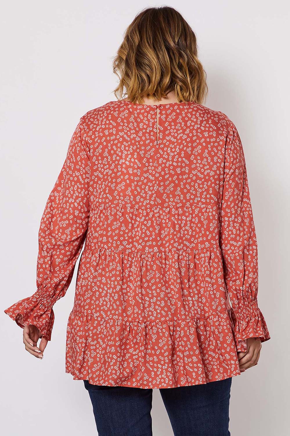 A model wearing the Floral Print Top in colour Orange, from the back
