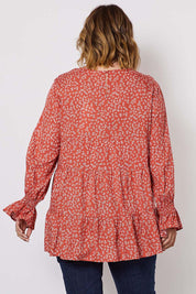 A model wearing the Floral Print Top in colour Orange, from the back