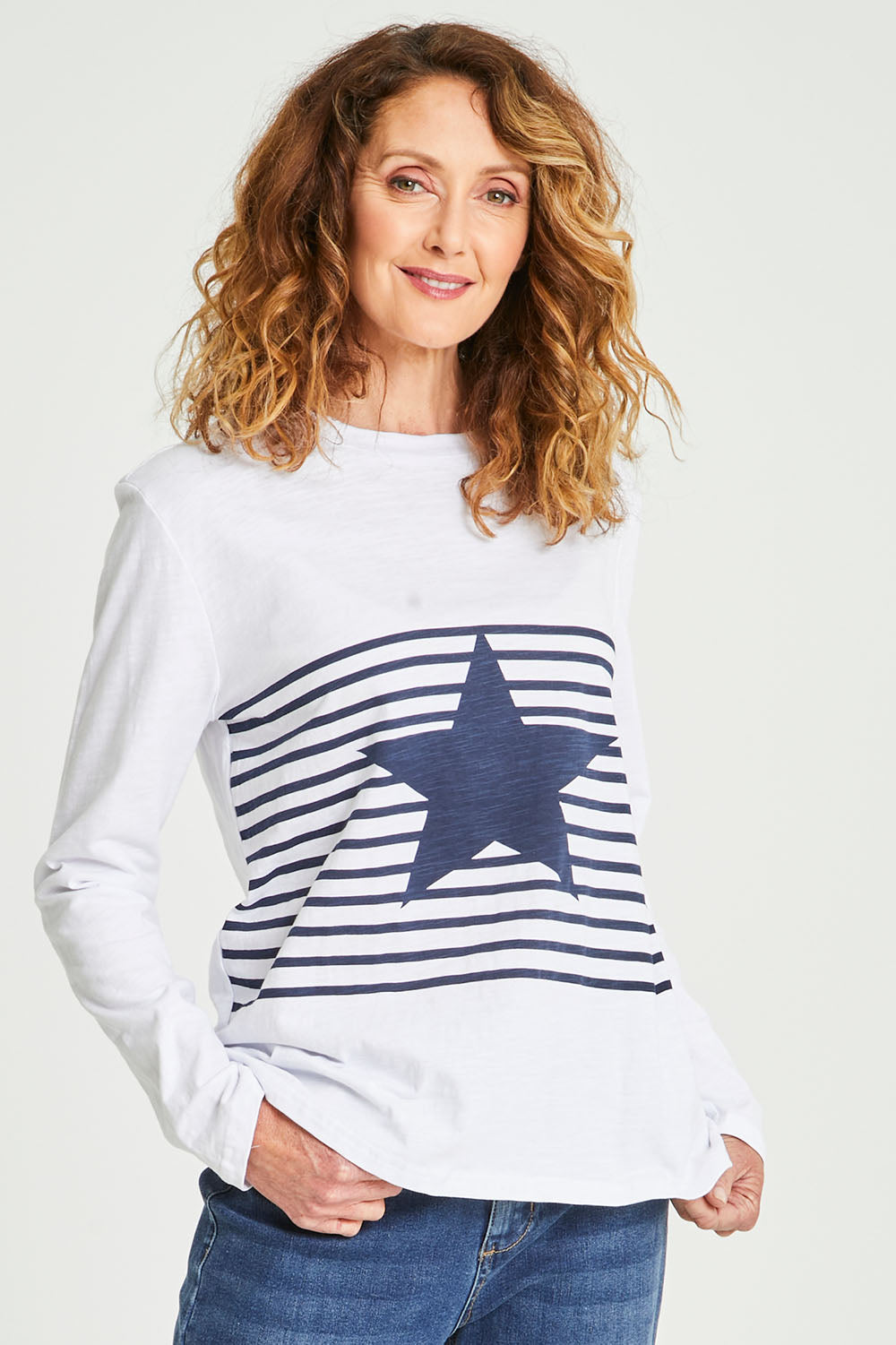 Model Emma wearing size S of the Star Stripe Tee in colour White (White), from the front, cropped image