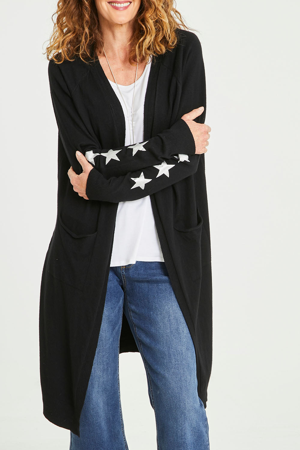 Model Emma wearing size S of the Longline Cardi in colour Black (Black), from the front, cropped image