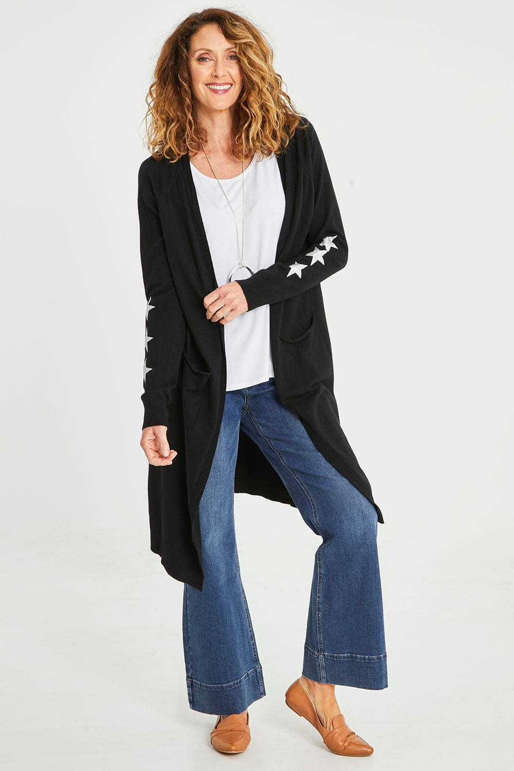 Model Emma wearing size S of the Longline Cardi in colour Black (Black), from the front, showing the whole outfit