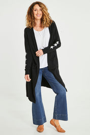 Model Emma wearing size S of the Longline Cardi in colour Black (Black), from the front, showing the whole outfit