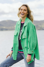 Model Alice wearing size S of the Zoe Cord Shacket in colour Jade (Green), from the front, showing the whole outfit