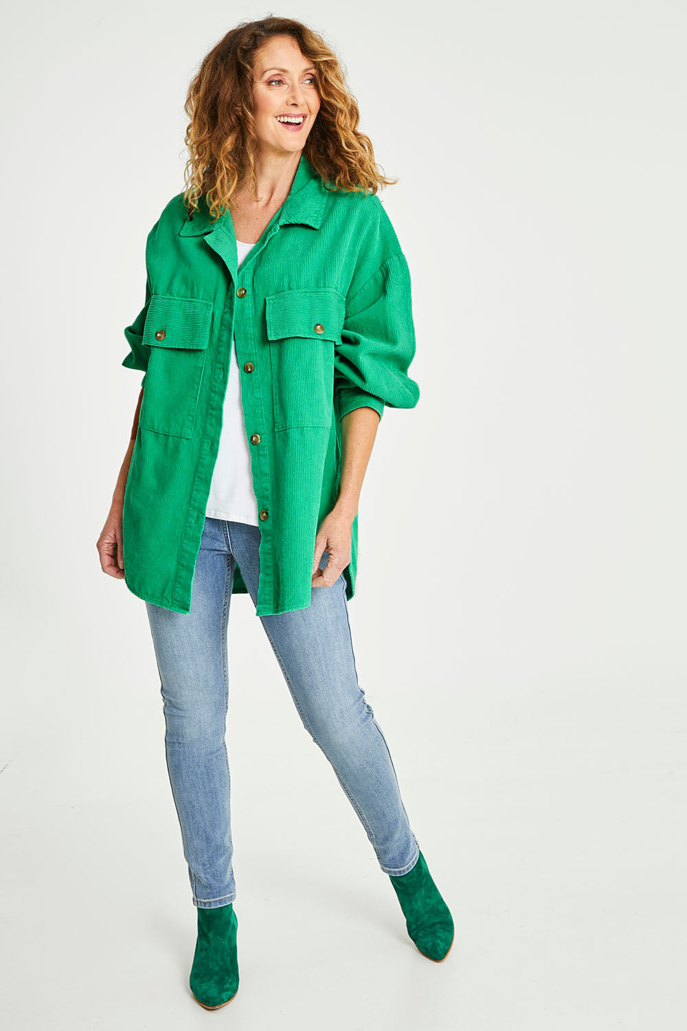 Model Emma wearing size S of the Zoe Cord Shacket in colour Jade (Green), from the front, showing the whole outfit