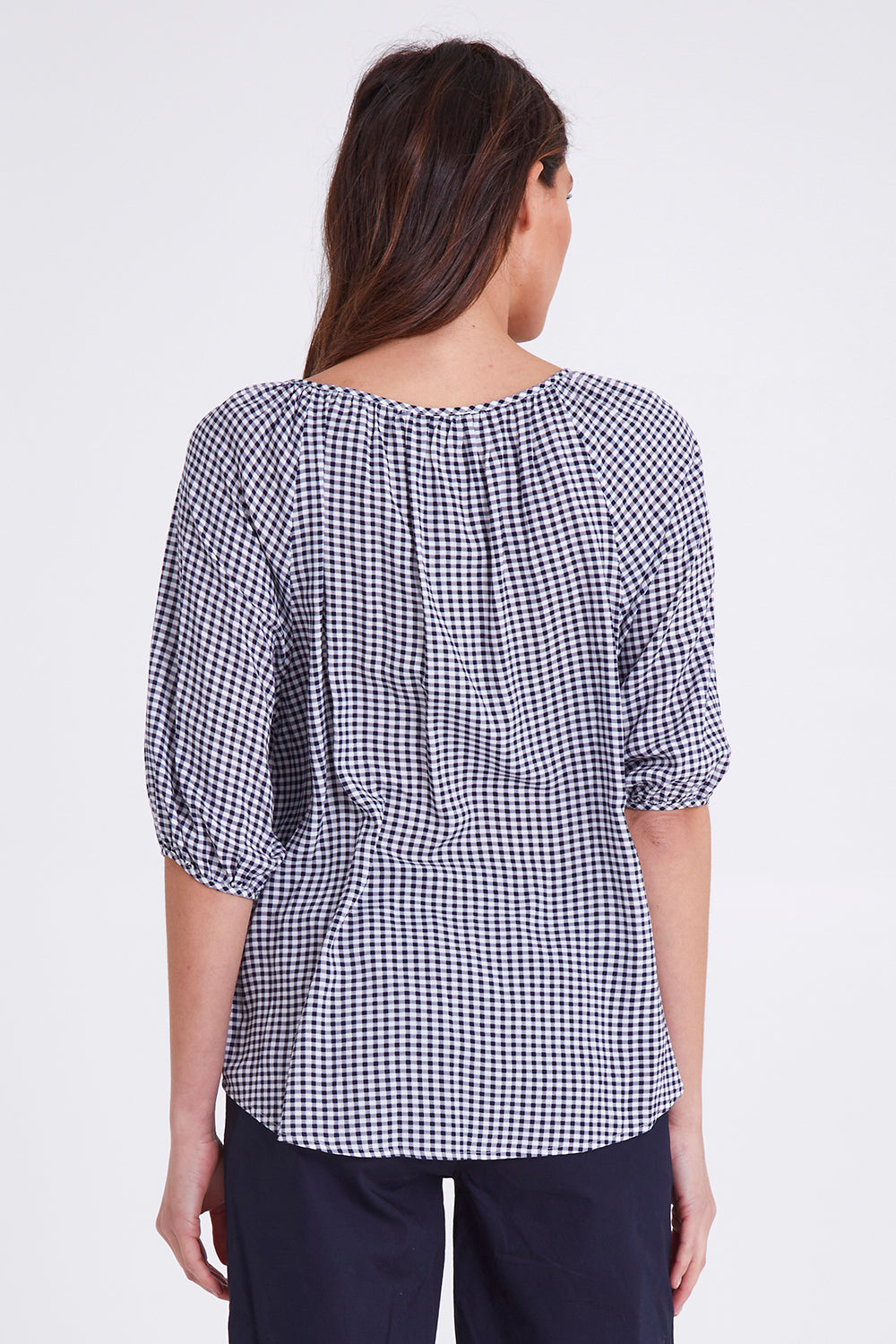 Model Madeline wearing size S of the Check It Out Top in colour Navy (Blue), from the back