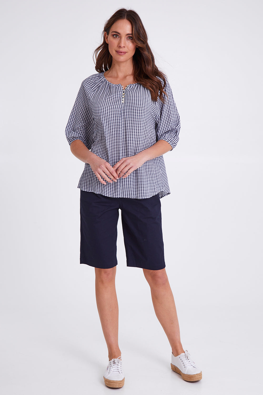 Model Madeline wearing size S of the Check It Out Top in colour Navy (Blue), from the front, showing the whole outfit