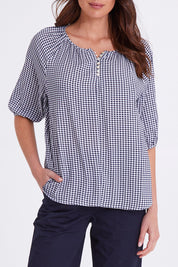 Model Madeline wearing size S of the Check It Out Top in colour Navy (Blue), from the front, showing the whole outfit