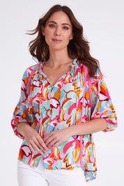 Model Madeline wearing size S of the Monet Top in colour Multi (Pink), from the front, cropped image