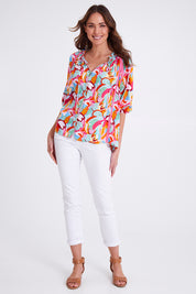 Model Madeline wearing size S of the Monet Top in colour Multi (Pink), from the front, showing the whole outfit