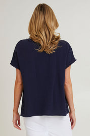 Model Grace wearing size S of the Byron Cotton Top in colour Navy (Blue), from the back