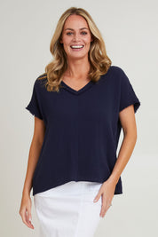 Model Grace wearing size S of the Byron Cotton Top in colour Navy (Blue), from the front, cropped image