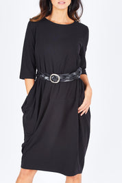 Model Gemma wearing size S of the Curved Seam Dress in colour Black (Black), from the front, cropped image