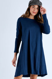 Model Madeline wearing size S of the Pleat Back Dress in colour Ocean (Blue), from the front, cropped image