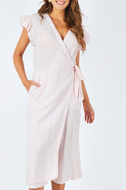 Model Madeline wearing size S of the Sunset Jumpsuit in colour Whitewild (White), from the front, cropped image