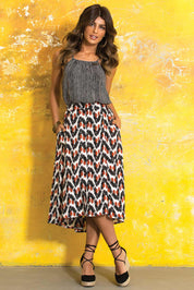 A model wearing the Ayna Skirt in colour BayamCream, from the front, showing the whole outfit