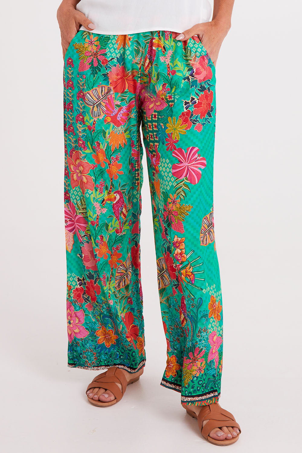 Model Luisa wearing size S of the Eastern Pant in colour Emerald (Green), from the front, cropped image