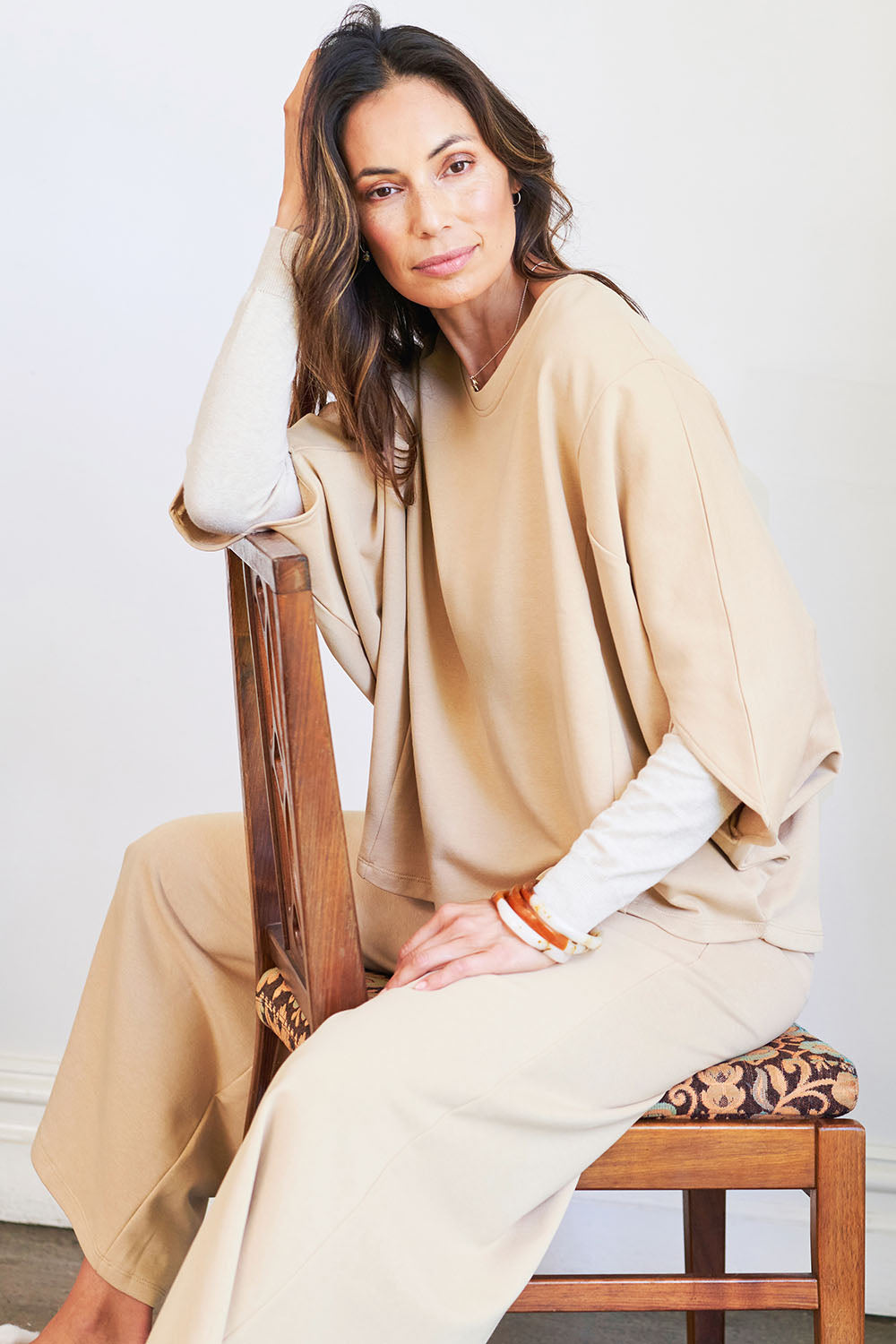 Model Amanda wearing the Cotton Terry Batwing Sweater in colour Porridge, from the front, cropped image
