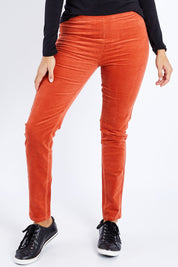 Model Lala wearing size 10 of the Skinny Leg Cord Pull On Pant in colour Auburn, from the front, cropped image