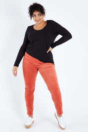 Model Sasha-Lee wearing size 16 of the Skinny Leg Cord Pull On Pant in colour Auburn, from the front, showing the whole outfit