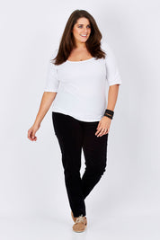 Model Mae wearing size 16 of the Skinny Leg Cord Pull On Pant in colour Black (Black), from the front, showing the whole outfit