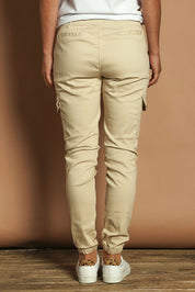 Model Katie wearing size 10 of the Harlow Cargo Jogger in colour Beige, from the back